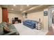 Finished basement with carpeted floor, blue couches, TV, and Avengers poster at 3950 Almandine Way, Cumming, GA 30040