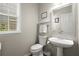 Powder room featuring a pedestal sink, window, and neutral wall color at 3950 Almandine Way, Cumming, GA 30040