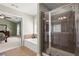 Well-lit bathroom featuring a glass-enclosed shower and a soaking tub at 3950 Almandine Way, Cumming, GA 30040