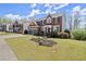 Lovely two-story brick home with a two-car garage and manicured front yard landscaping in a neighborhood at 3950 Almandine Way, Cumming, GA 30040