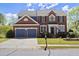 Charming two-story brick home with a well-manicured lawn and attached two-car garage at 3950 Almandine Way, Cumming, GA 30040