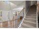 Spacious foyer featuring hardwood floors, a staircase with rod iron spindles, and an open view to the living space at 3950 Almandine Way, Cumming, GA 30040