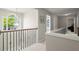 Bright hallway featuring wood and metal railing, arched window and views of other rooms at 3950 Almandine Way, Cumming, GA 30040