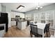 Eat-in kitchen with white cabinets, black appliances, and a center island at 3950 Almandine Way, Cumming, GA 30040