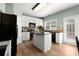 Well-equipped kitchen with white cabinets, black appliances, and a central island at 3950 Almandine Way, Cumming, GA 30040