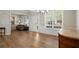 Inviting living room showcasing large windows, a chandelier, and wood-look flooring at 3950 Almandine Way, Cumming, GA 30040