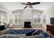 Sunlit living room features a fireplace, vaulted ceilings, and wood-look flooring at 3950 Almandine Way, Cumming, GA 30040