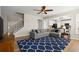 Cozy living room with open floorplan, a plush blue rug, and staircase access at 3950 Almandine Way, Cumming, GA 30040