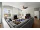 Open-concept living room boasts a fireplace, large windows and comfortable seating at 3950 Almandine Way, Cumming, GA 30040