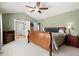 Primary bedroom with a ceiling fan, vaulted ceiling, and ensuite bathroom at 3950 Almandine Way, Cumming, GA 30040