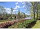 Scenic view of a pond surrounded by trees and landscaping at 3950 Almandine Way, Cumming, GA 30040