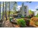Spacious backyard featuring lush landscaping, a covered patio with seating, and an inviting stone fire pit at 4620 Westgate Dr, Cumming, GA 30040