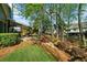 Spacious backyard with lush lawn, mature trees, and a covered patio, perfect for outdoor enjoyment at 4620 Westgate Dr, Cumming, GA 30040