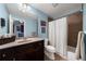 Bathroom with single vanity, a large mirror, and a shower-tub combination with a white curtain, complemented by blue walls at 4620 Westgate Dr, Cumming, GA 30040