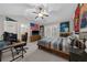Spacious bedroom with sports memorabilia, a bed with striped bedding, and desk area for work or gaming setup at 4620 Westgate Dr, Cumming, GA 30040