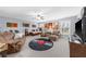 Spacious bonus room with a vinyl record rug, sofa, chairs, a ceiling fan, and a television, perfect for entertainment at 4620 Westgate Dr, Cumming, GA 30040