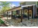 Inviting covered patio with cozy seating, an outdoor grill, ceiling fans, and a decorative stone floor perfect for entertaining at 4620 Westgate Dr, Cumming, GA 30040