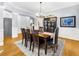 Elegant dining room with hardwood floors, a large table with seating for eight, and a stylish chandelier at 4620 Westgate Dr, Cumming, GA 30040