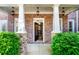 Charming entrance with brick pillars, stone accents, and elegant lighting fixtures at 4620 Westgate Dr, Cumming, GA 30040