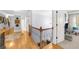 Upstairs hallway with hardwood floors and decorative railing at 4620 Westgate Dr, Cumming, GA 30040