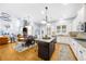 Open concept kitchen and living area featuring granite island and stainless appliances at 4620 Westgate Dr, Cumming, GA 30040