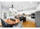Bright kitchen with stainless appliances, double ovens, granite countertops, island and adjacent dining area at 4620 Westgate Dr, Cumming, GA 30040