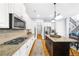 Bright kitchen features white cabinets, stainless appliances and a dark wood kitchen island with granite countertops at 4620 Westgate Dr, Cumming, GA 30040