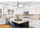 Modern kitchen with white cabinets, granite countertops, and stainless steel appliances at 4620 Westgate Dr, Cumming, GA 30040