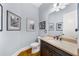 Stylish powder room features hardwood floors, dark vanity with light countertop and decorative mirror at 4620 Westgate Dr, Cumming, GA 30040
