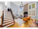 Staircase view of an open floor plan living room with a fireplace, high ceilings, and comfortable seating at 4620 Westgate Dr, Cumming, GA 30040