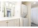 Well-lit bathroom with modern vanity, vessel sink, and stacked washer and dryer for convenience at 1101 Collier Nw Rd # U2, Atlanta, GA 30318