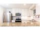 Modern kitchen with granite countertops, stainless steel appliances, and ample cabinet space at 1101 Collier Nw Rd # U2, Atlanta, GA 30318