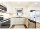 Bright kitchen featuring stainless appliances, white cabinets, granite counters, and subway tile backsplash at 1101 Collier Nw Rd # U2, Atlanta, GA 30318