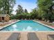 Sparkling community pool surrounded by lush greenery and lounge chairs at 1101 Collier Nw Rd # U2, Atlanta, GA 30318