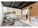Cozy screened-in porch with brick accents, comfortable seating, and a view of the surrounding greenery at 1101 Collier Nw Rd # U2, Atlanta, GA 30318