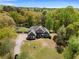 Aerial view of a stately home featuring beautiful landscaping, a circular driveway, and a vast, tree-lined property at 1350 Blackwell Rd, Marietta, GA 30066