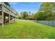 Expansive, green backyard with a wooden fence and a view of the home's deck at 1350 Blackwell Rd, Marietta, GA 30066