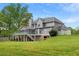 Overlooking the home's expansive, well-manicured backyard, complemented by a charming deck and stone foundation at 1350 Blackwell Rd, Marietta, GA 30066