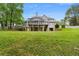 Large backyard with green grass and a view of the back of the home featuring a deck and garage at 1350 Blackwell Rd, Marietta, GA 30066