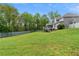 Large green backyard showcasing the home's screened deck and a sturdy wooden fence for privacy and security at 1350 Blackwell Rd, Marietta, GA 30066