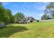 Expansive backyard featuring green grass, fenced perimeter, and a partial view of the home's screened-in deck at 1350 Blackwell Rd, Marietta, GA 30066