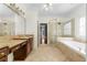 Bathroom featuring soaking tub, glass shower, tile floors, and dual vanities at 1350 Blackwell Rd, Marietta, GA 30066