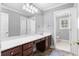 Bright bathroom featuring a vanity with wooden cabinets, a wide mirror, and a glimpse into the toilet area at 1350 Blackwell Rd, Marietta, GA 30066