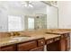Bathroom with double sink vanity, granite countertops, and decorative mirror at 1350 Blackwell Rd, Marietta, GA 30066
