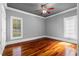 Inviting bedroom with hardwood floors, a ceiling fan, and natural light from two windows at 1350 Blackwell Rd, Marietta, GA 30066