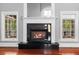 Close-up of a fireplace featuring black granite surround, white mantel, flanked by large windows at 1350 Blackwell Rd, Marietta, GA 30066