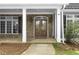 Inviting entryway with a wood double door, flanked by windows and classic brickwork at 1350 Blackwell Rd, Marietta, GA 30066