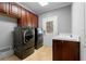 Laundry room featuring washer, dryer, sink, storage cabinets and tile flooring at 1350 Blackwell Rd, Marietta, GA 30066