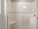 Tiled shower stall featuring a glass door, a built-in seat, and modern fixtures at 1350 Blackwell Rd, Marietta, GA 30066