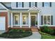 Inviting front porch with a wreath, brick accents, fresh landscaping, and a well-manicured lawn at 139 Thunder Ridge Ln, Acworth, GA 30101